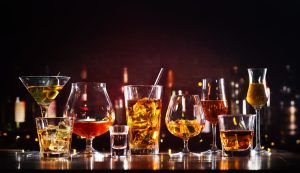 Assortment of hard strong alcoholic drinks and spirits in glasses on bar counter - 4 Common signs of alcoholism concept image