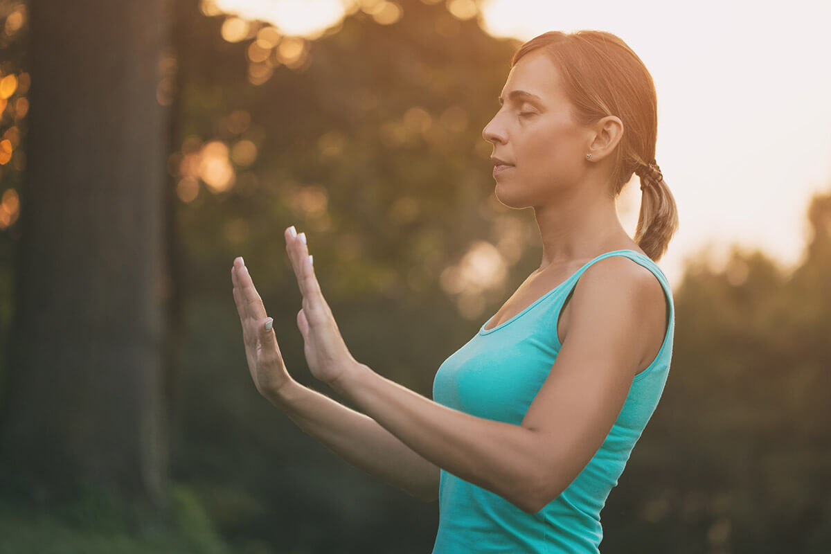 woman outside meditating learning how to practice patience