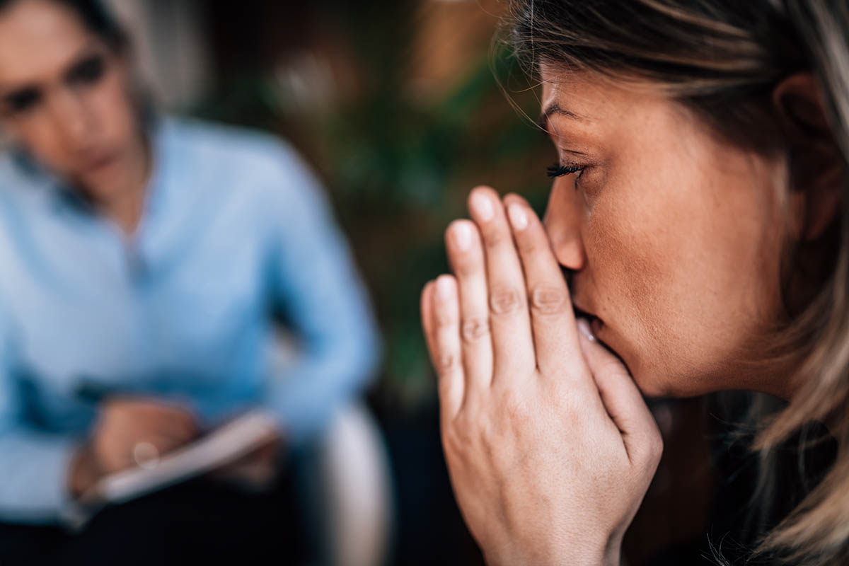 woman with prayer hands dealing with behavioral addictions