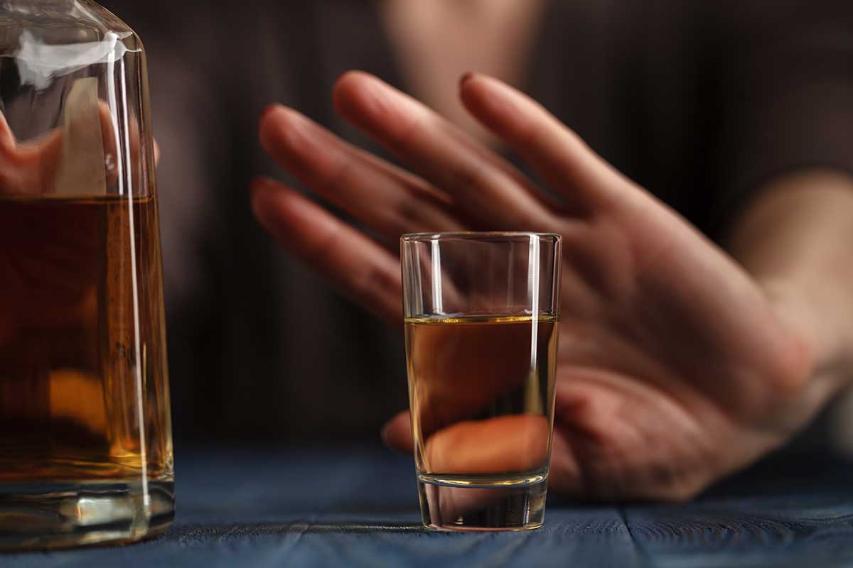 person refusing a shot in effort to staying sober