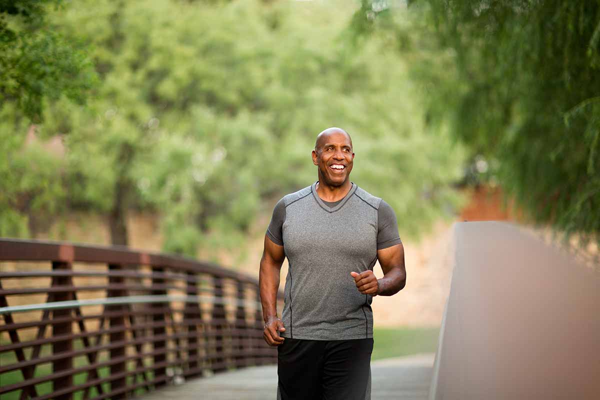 man jogging and celebrating men's health month