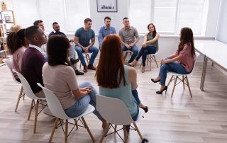 people in group therapy discussing its benefits