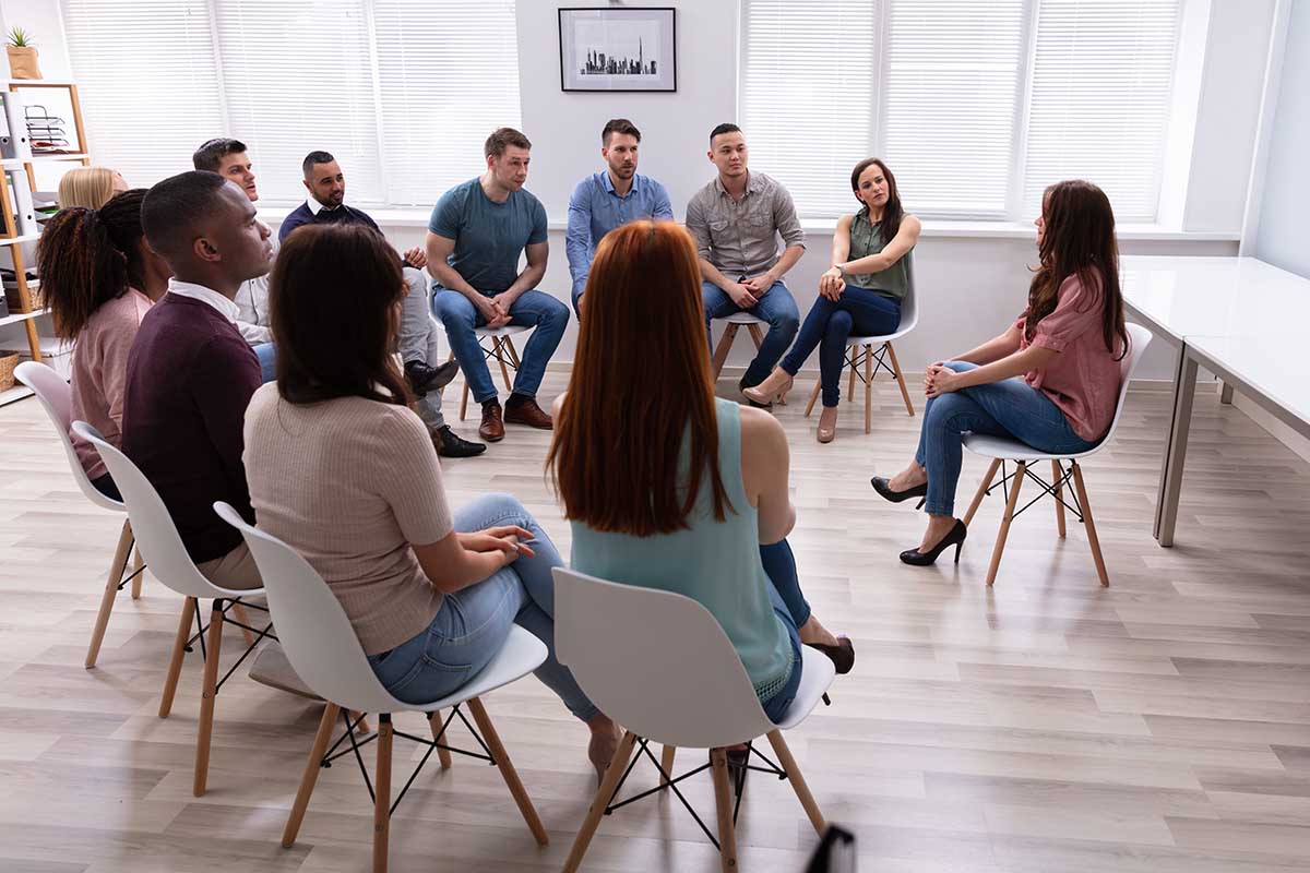 people in group therapy discussing its benefits