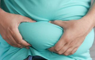 Person grabbing stomach fat