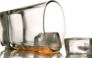 Spilt over whiskey glass.