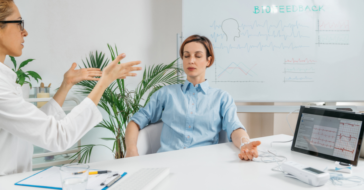 A doctor guides her patient through biofeedback.