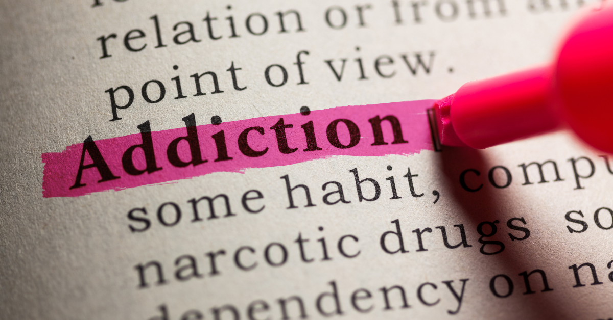 The word "addiction" highlighted in a dictionary.