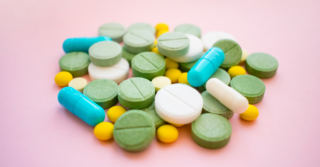 A pile of differently colored and shaped pills.